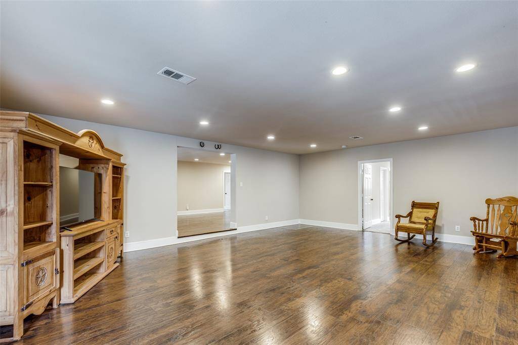 View of the other side of the family room. Primary bedroom located through the door on the right side.