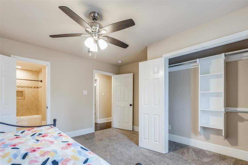 Secondary Bedroom # 2 with ceiling fan and built-in storage/shelving in the closet. Jack & Jill Bathroom connected to this bedroom.
