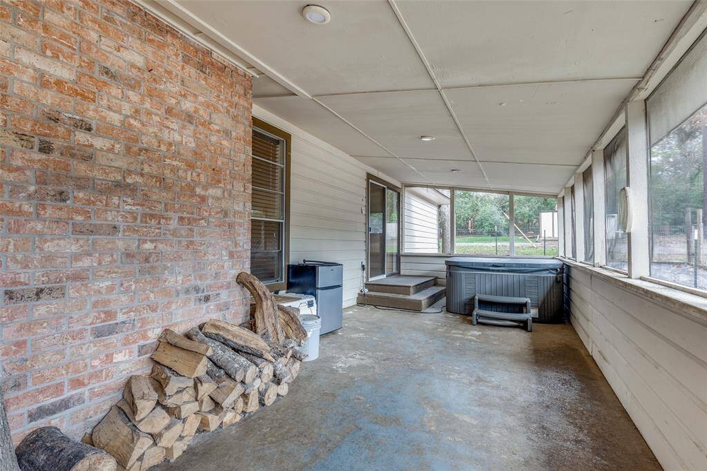 Screened in porch located at the back of the home with a view of the shop. Swim Spa Hot Tub with cover- new 2018, jetted & plug in- not wired.