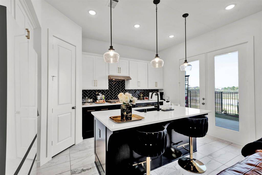 Open sightlines flow seamlessly from the kitchen to the living and dining areas — perfect for modern living.