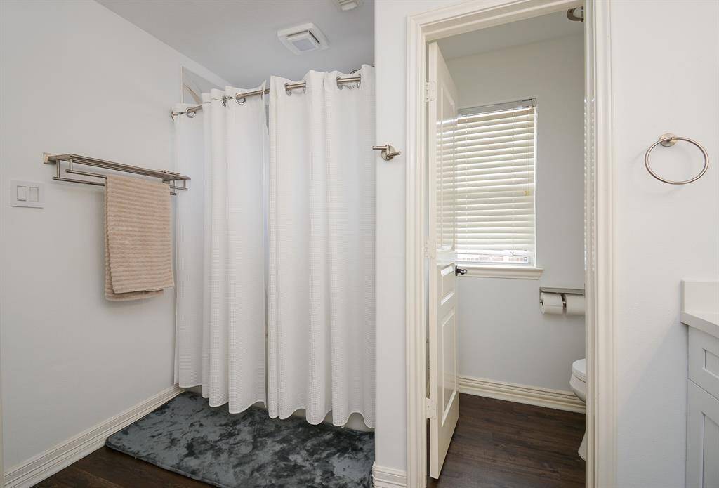 Privacy and functionality define this second bathroom space.
