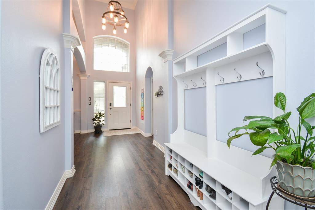 Just divine! Picture yourself welcoming guests into your incredible home; with first impressions consisting of heavenly high ceiling, shining floor, and pure neutral tones on walls/accents, including this charming 'mud room' feature, right.
