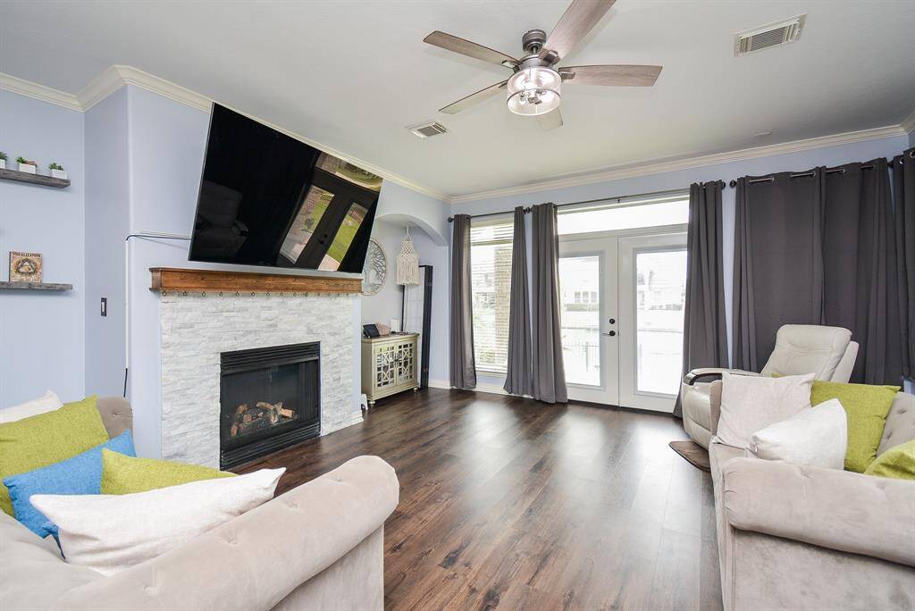 This is just one comfy view of your living/family area, with high ceiling, neutral tones on walls and shining laminate floor; and the star of the show: the brick enclosed fireplace, sure to warm spirits in any season. Dual patio doors open onto your huge backyard.