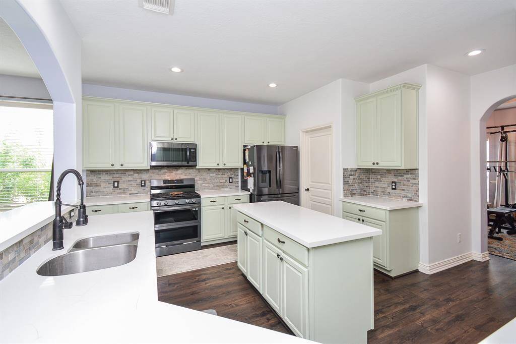 When you see this truly amazing kitchen, picture yourself at the dual stainless sinks, facing the living area, and pop open that celebratory bottle of champagne to christen your incredible new home! (And, while you're celebrating, a family member may be working out, in designated space, right!)