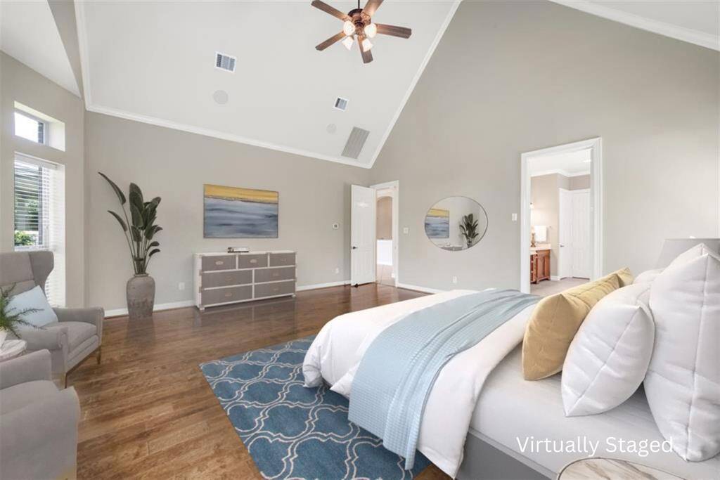 Finishing up this private sanctuary are beautiful wood flooring, crown molding, an ensuite bathroom, and vaulted ceilings with a ceiling fan.