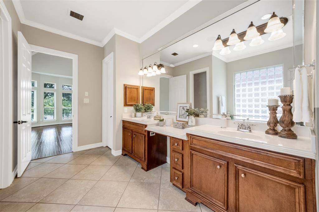 Step into the beautiful primary ensuite bathroom, where luxury meets functionality. This spacious oasis features gorgeous cabinets, a large mirror, and dual sinks, providing ample space for getting ready in the morning. With convenient knee space, medicine cabinet, linen closet, and expansive his and her closets, this bathroom has everything you need for comfort and organization.