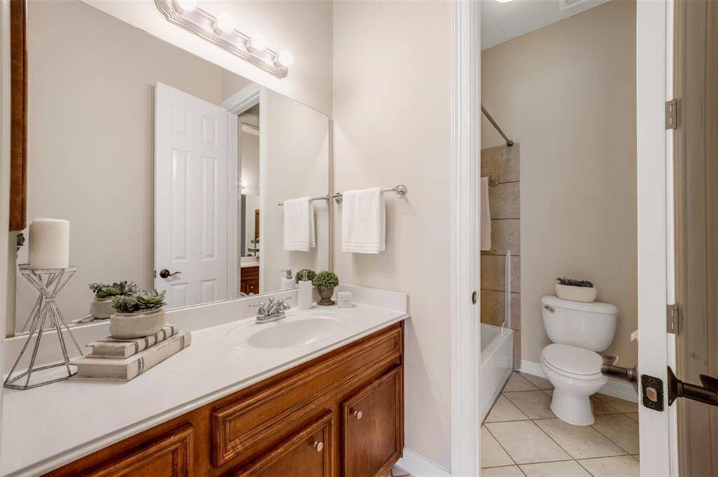 Direct access to the Jack and Jill bath where twobedrooms share a tub/ shower combo with tilesurround, tile flooring and identical extendedvanities.