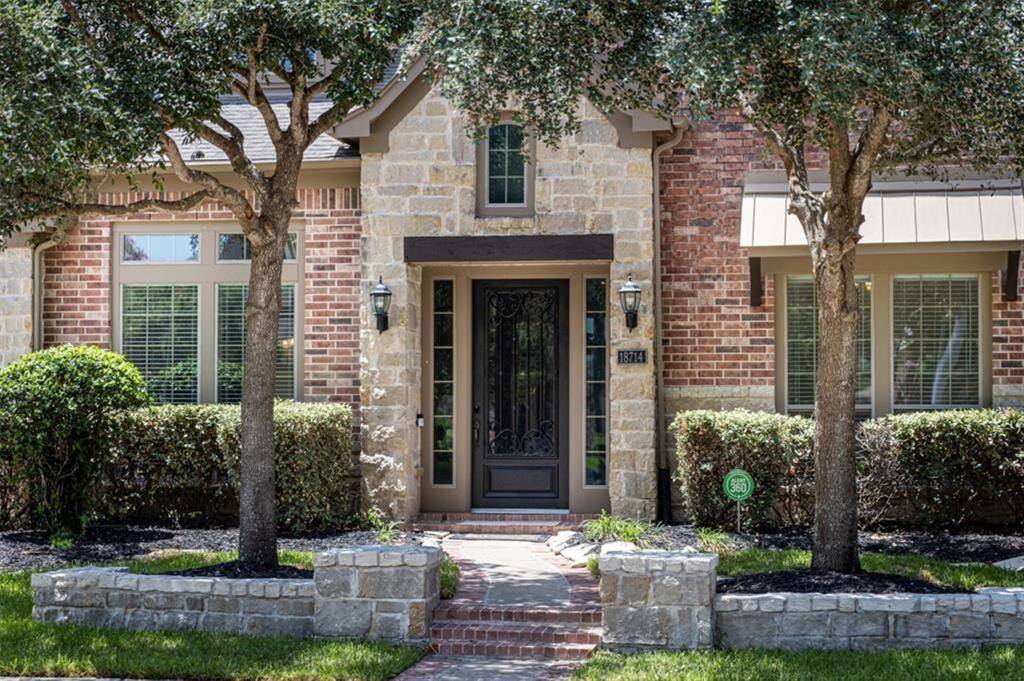 As you enter up the brick accented steps you are greeted by beautiful flower beds on either side, with mature trees providing shade that adds to the picturesque landscaping. Full sprinkler system helps keep your landscaping lush all year round.