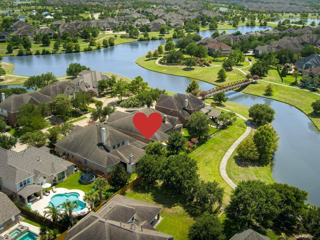 This aerial view showcases the home nestled in its lush surroundings!  Imagine coming home to this serene environment every day!