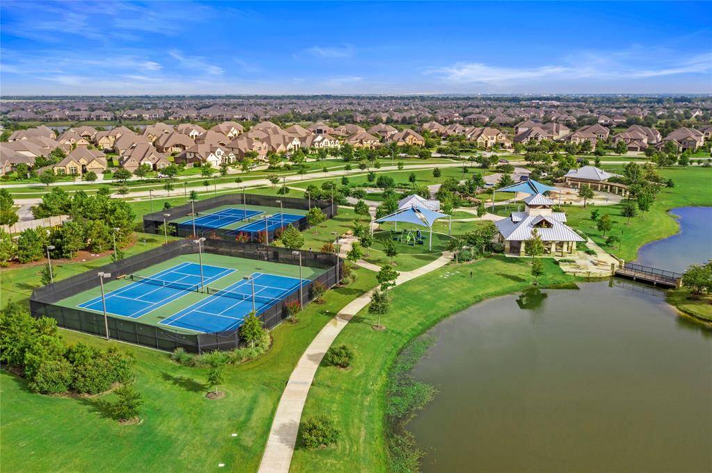 This overhead view of Lakeland Village Park showcases tennis, covered playgrounds, pavilion, splash pad and lap pool, all just a short walk from your new home.