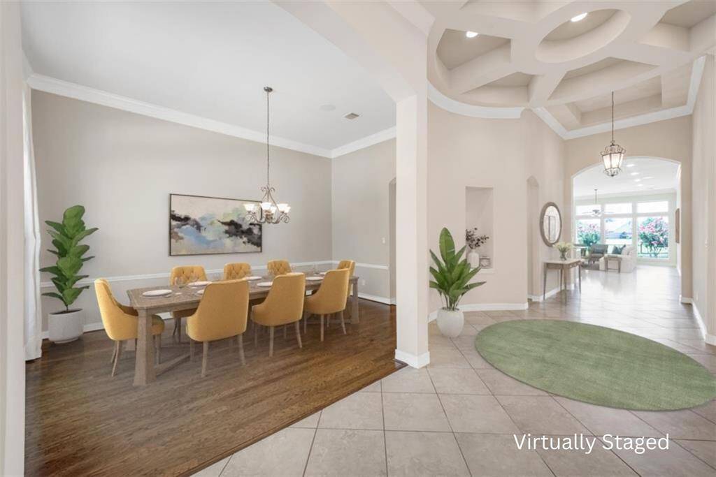 As you step further into the foyer, you'll be captivated by the magic of the home. Take a moment to admire the stunningly detailed tray ceiling in the rotunda. Open to both the study and the formal dining, you'll notice the attention to detail and the thoughtfully designed features that make this space truly remarkable.