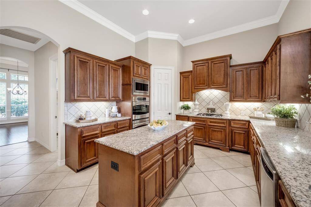 With easy access to the formal dining area, this kitchen is a chef's delight. You will love cooking and entertaining in this spacious and well-appointed culinary gem. It features double ovens, built-in microwave, Bosch dishwasher (installed 2024), walk-in pantry and tons of cabinet storage.