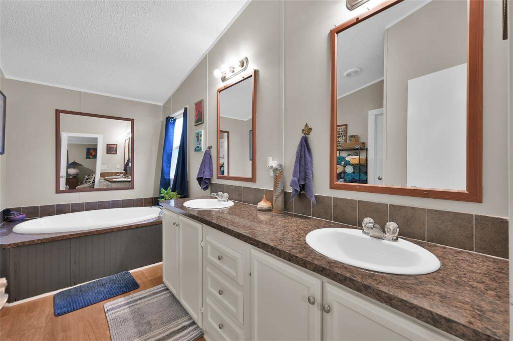 Double sinks with soaking tub. Great space to relax and unwind.