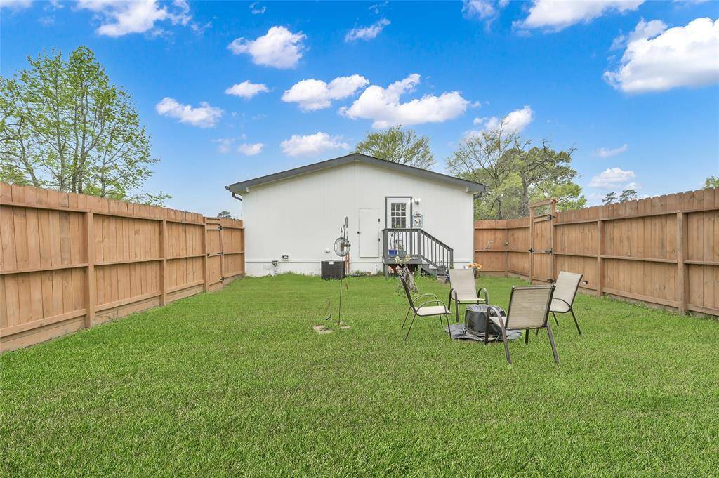 View from the fenced in area of property looking to the side door off the laundry room. Perfect if you have pets.