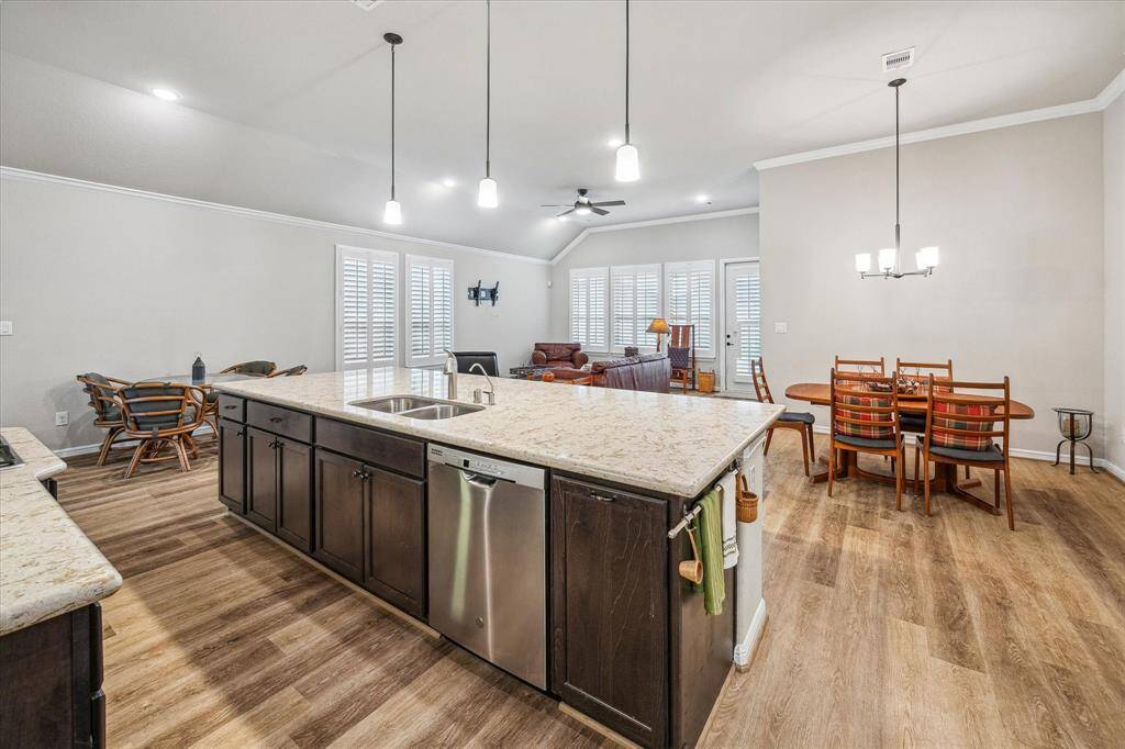From the Kitchen looking out to the space showing off there is room for Game table, Dining Table, bar stools and large Living room area.