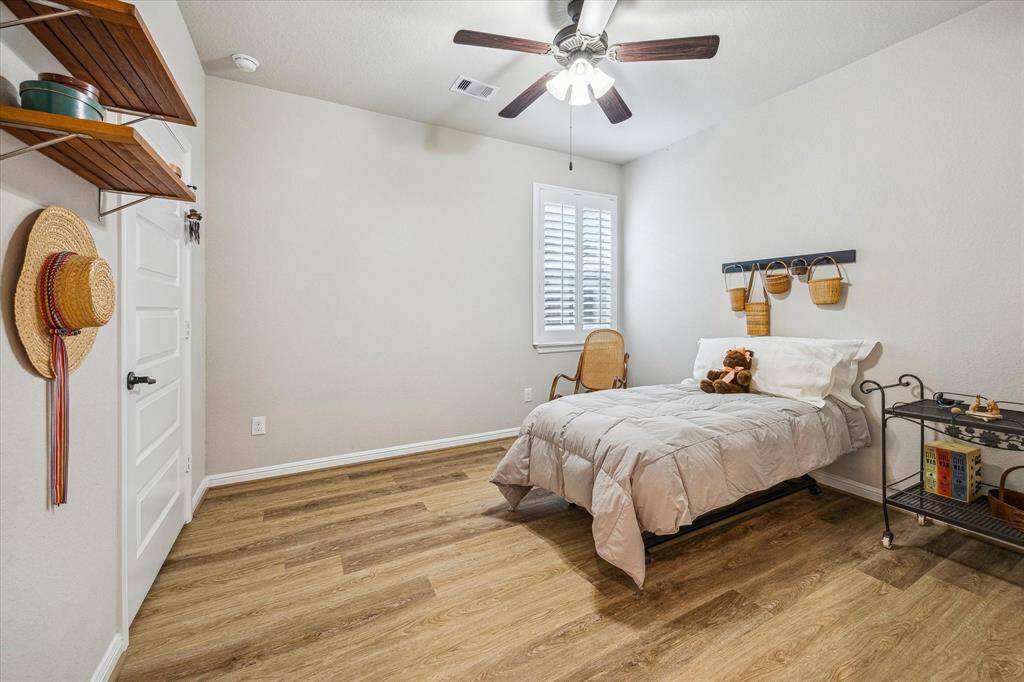 The secondary bedroom is located at the back of the home in this split style floorplan.  Room features a walk in closet and right across the hall is the guest bathroom for easy access.