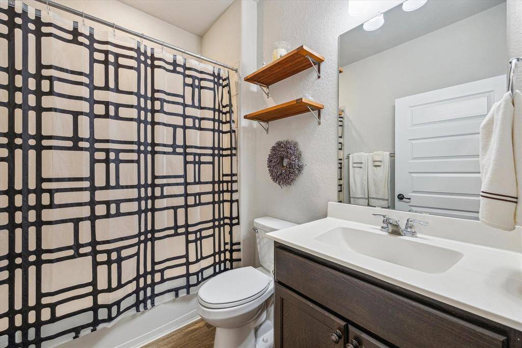 Across from the guest bedroom is the full secondary bathroom.  Vanity has plenty of storage space.