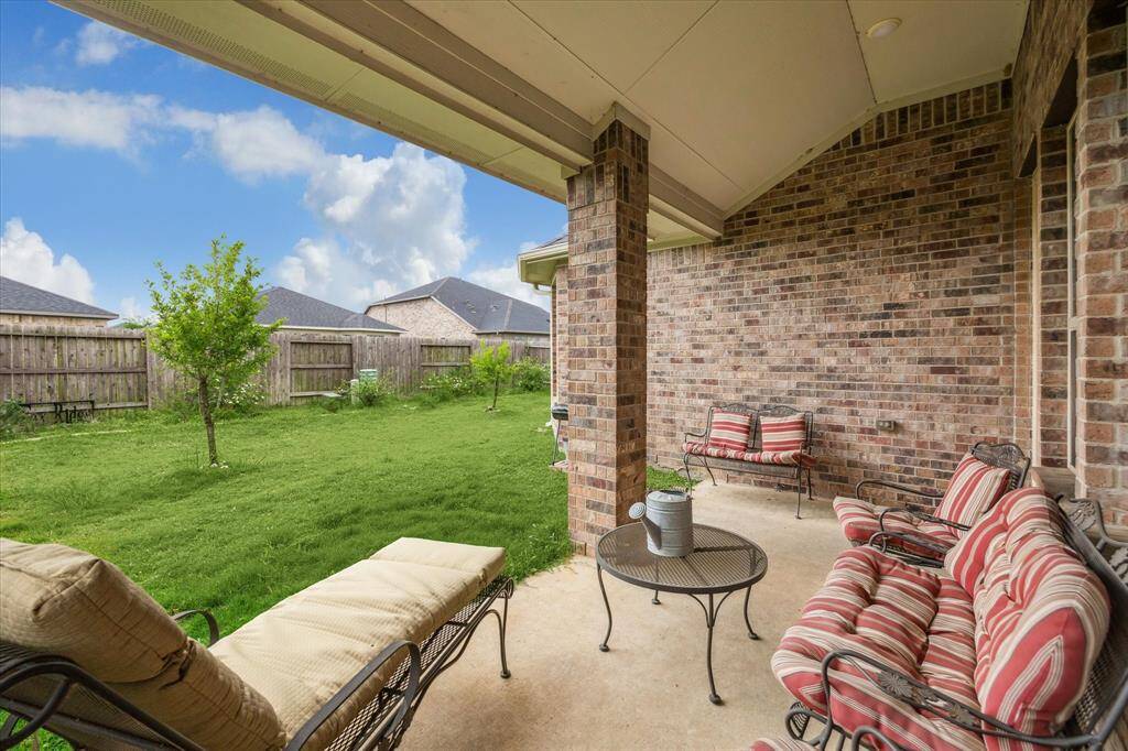 There is a full covered patio at the rear of the home with plenty of room for additional lliving area.  Home faces east so no backyard sun.