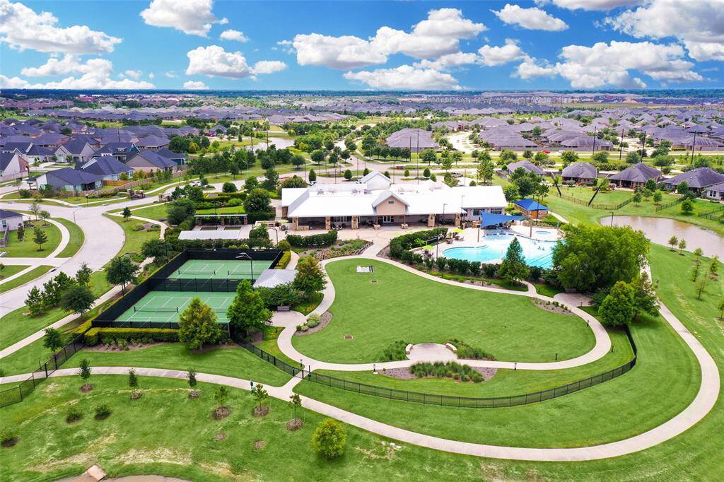 Ariel view of the over 10,000 sq ft clubhouse that is exclusive for Bonterra residents.   This area includes pickle ball courts, bocce ball courts, public area with fire pits and furniture, resort style pool. cabanas, spa, and walking trail around the lake.