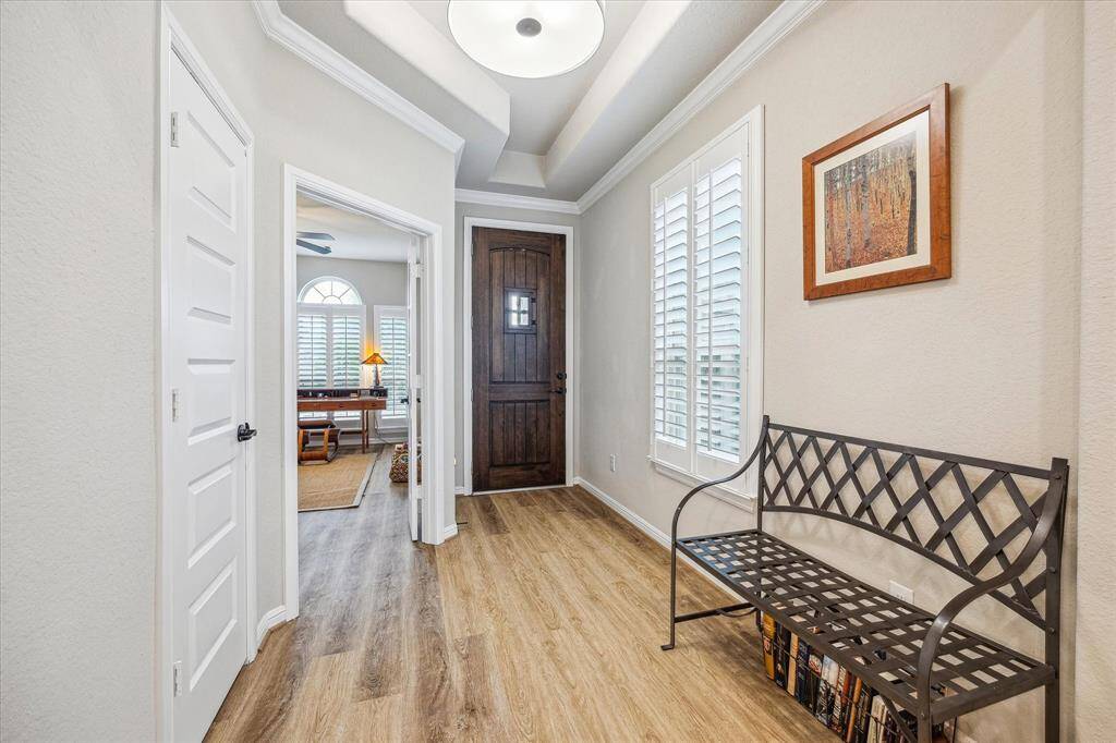 There is no carpet in the entire home, all floors are wood planked luxury vinyl flooring. The Office is located at the front of the home and there is a tray ceiling to set apart the foyer space. Extensive crown molding in the entire living area.