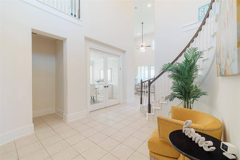 Two story vaulted ceilings with Beautiful stair case greet you in this Grand Foyer.