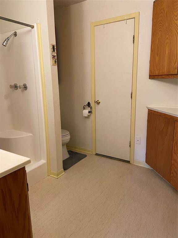 Large bathroom with shower & plenty of cabinets for storage