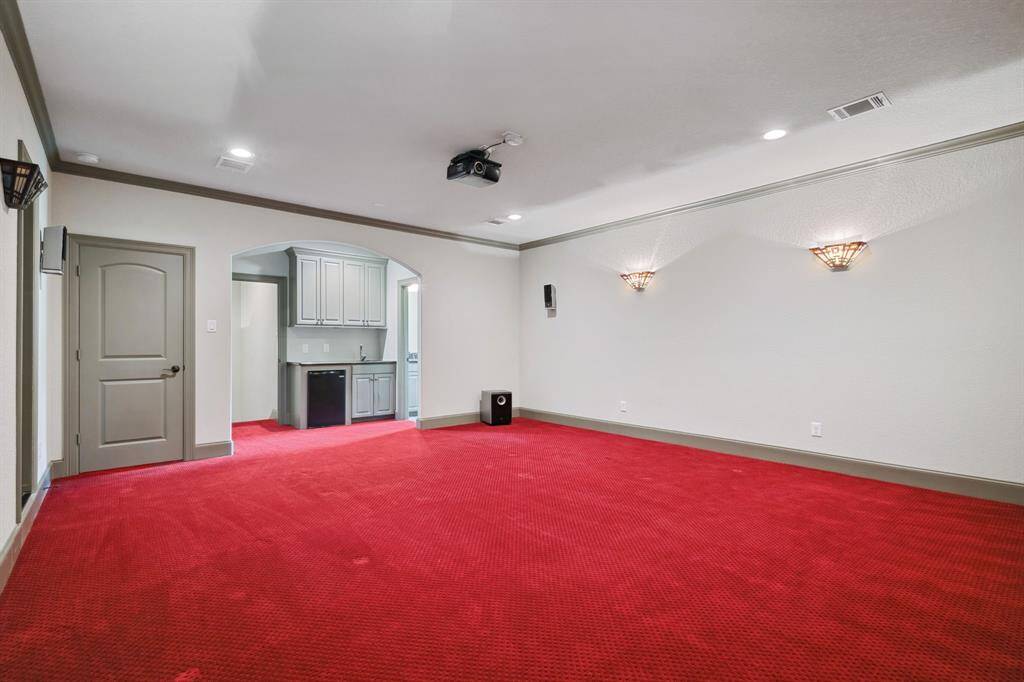 Media room up with wet bar area and half bath.