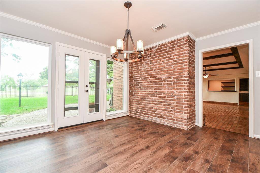 Formal dining room is adjacent to kitchen and living room featuring floor to ceiling windows enhancing the beautiful golf course and water views