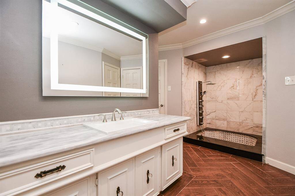 Other side of the bathroom with separate vanity and light up mirror