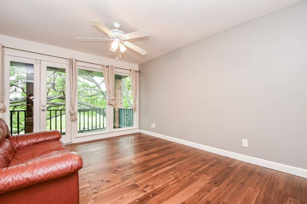 Bedroom #4 also has balcony access and the beautiful wood floors
