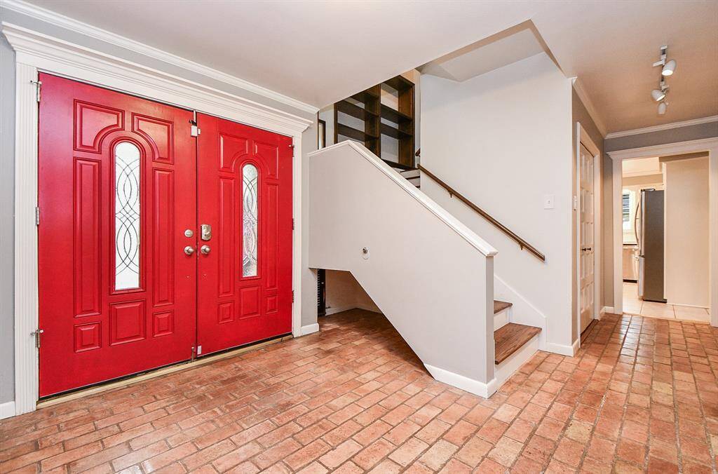 Double front doors greet you as you enter.  Sneak peek into kitchen through opening