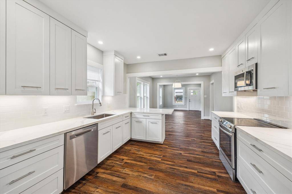 All new kitchen with SS appliances, quartz counters, subway tile back splash, plenty of new upper and lower cabinets for storage