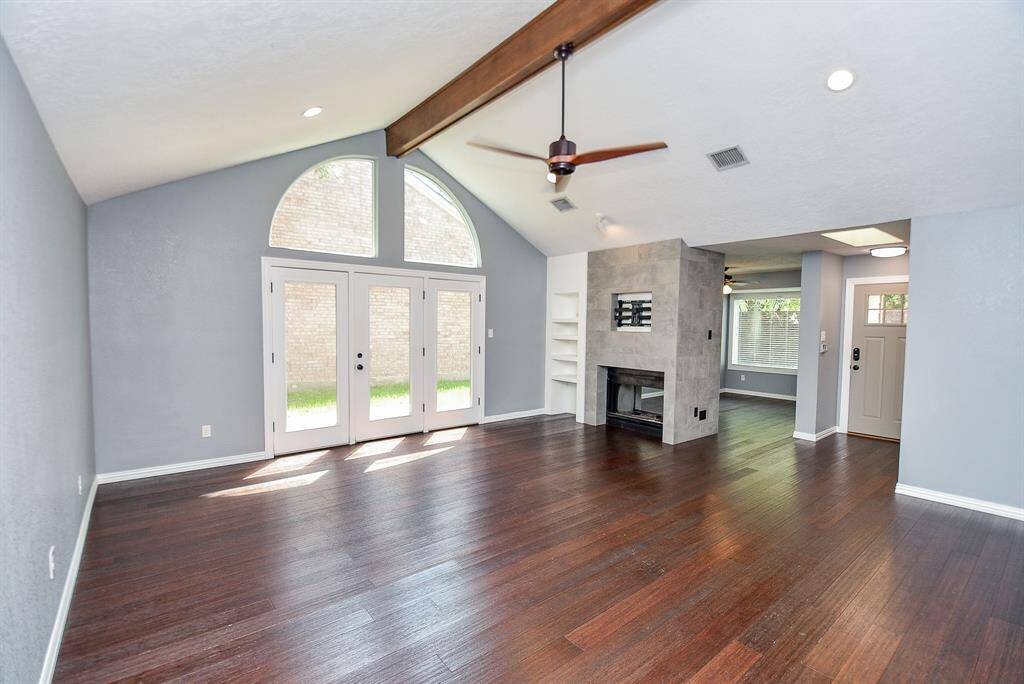 The "wall of windows" with double French Doors leading to the courtyard/patio area is beautiful.