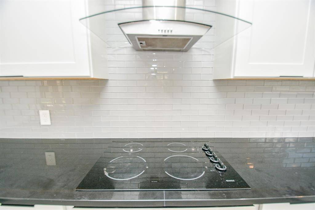 The vent hood in the kitchen is very modern and beautiful.