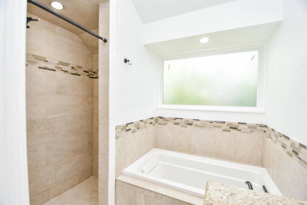 There is an oversized soaking tub and separate shower.