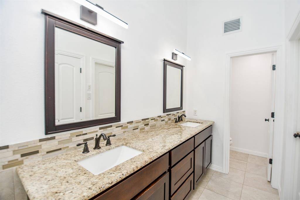 Another view shows the counter space and storage on the double vanity area.