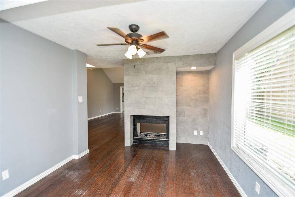 The Study/Front sitting area has a fireplace (2 sided) and shelving and a ceiling fan.