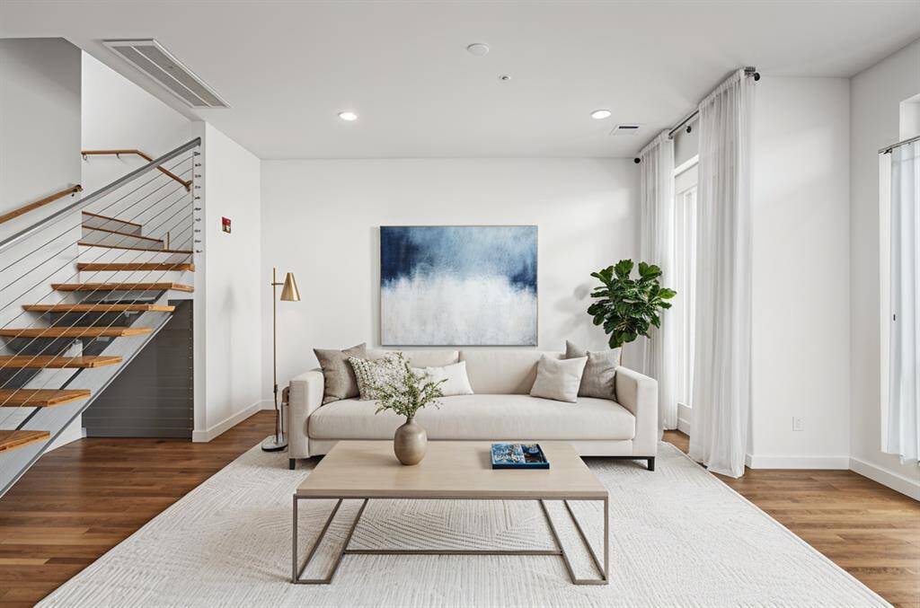 Spacious, well-lit, and airy living area enhanced by wide, floor-to-ceiling windows that flood the space with natural light, creating an inviting and open atmosphere.