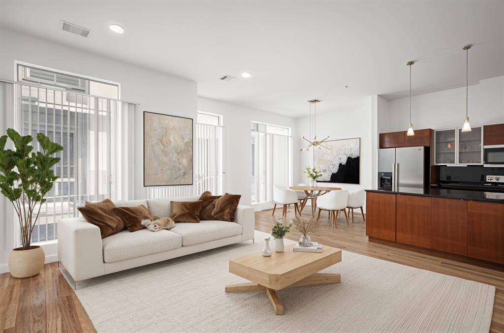 Open concept layout that seamlessly connects living, dining, and kitchen areas, creating a spacious and airy environment perfect for modern living and entertaining.