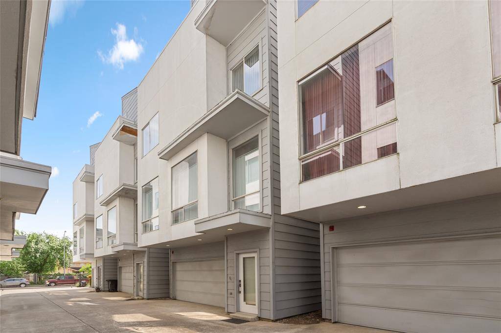 Modern multi-level townhome with a sleek exterior design, featuring large windows for natural light and a spacious two-car garage. Located in a secure and well-maintained community with easy access to nearby amenities