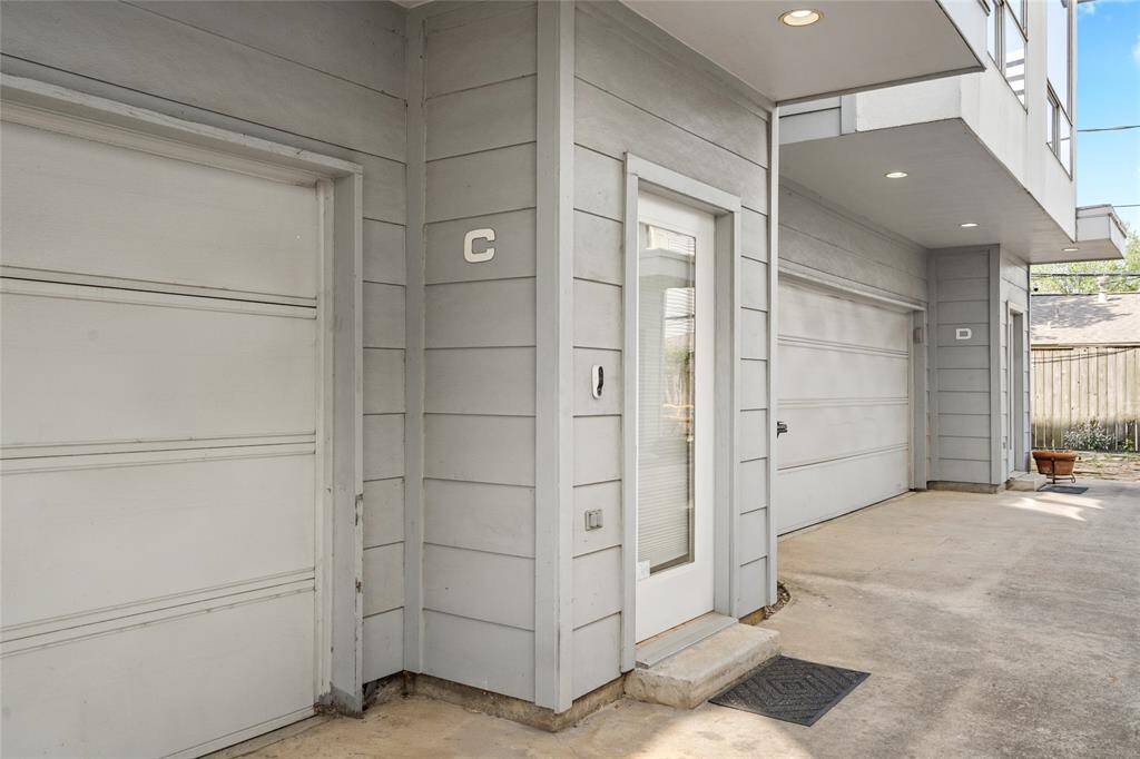 Private entryway with a modern glass-paneled door, complemented by a covered entrance for added convenience. The attached two-car garage provides secure parking and additional storage space.