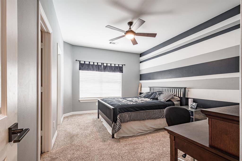 Lovely upstairs bedroom with stunning views overlooking the pool.  This spacious room is complemented by its own en-suite bath and large walk-in closet.
