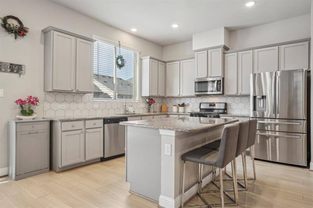Kitchen open to living dining and living. Quartz counters and soft closing cabinets.