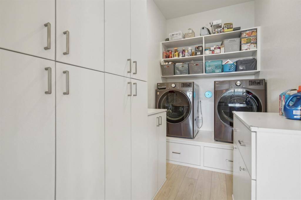 Laundry room with custom cabinets and storage.