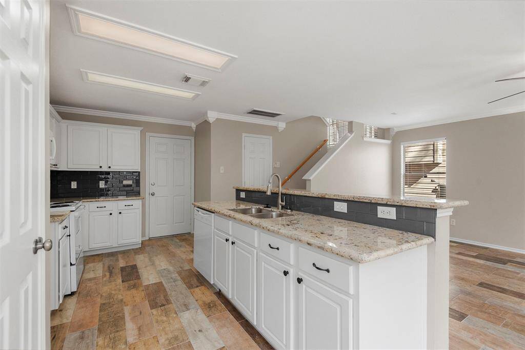 The breakfast bar offers an additional space for dining or casual conversation. It also serves as a divider between the kitchen and living room.