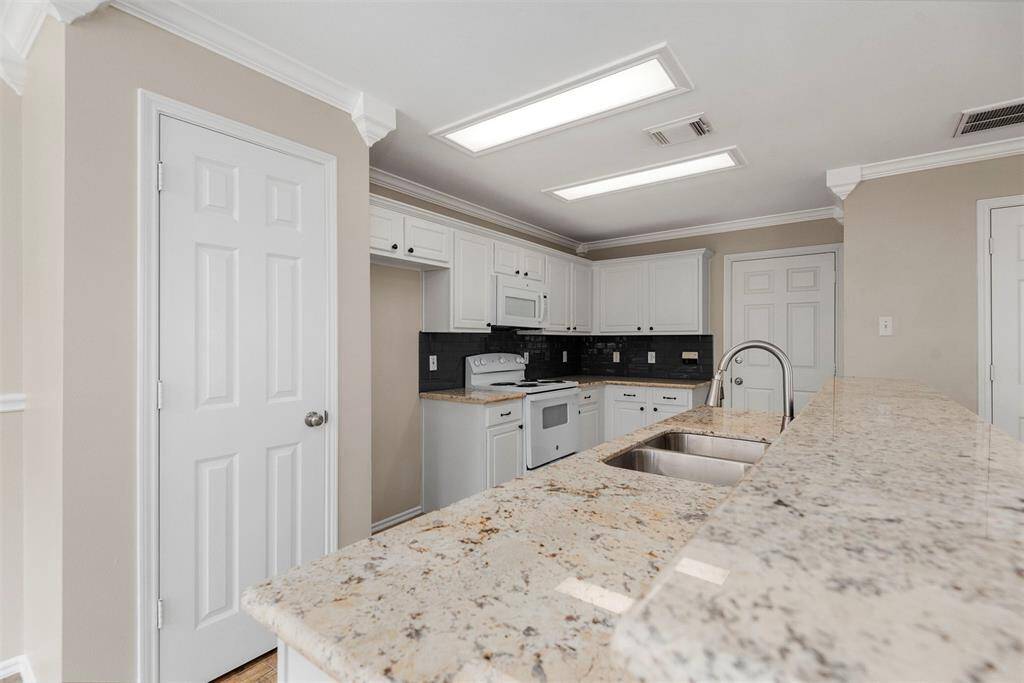 This kitchen is enhanced by the new beautiful granite countertops, which set the tone for the room.