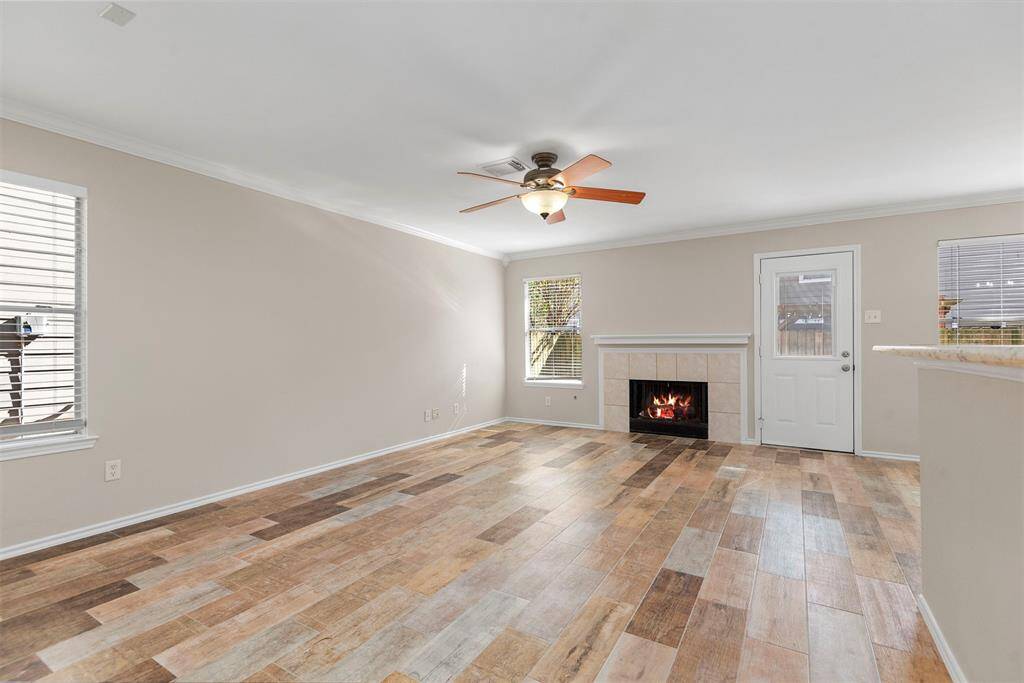 The living room has new wood plank tile flooring. The natural light and new flooring adds a lot of warmth to the room.