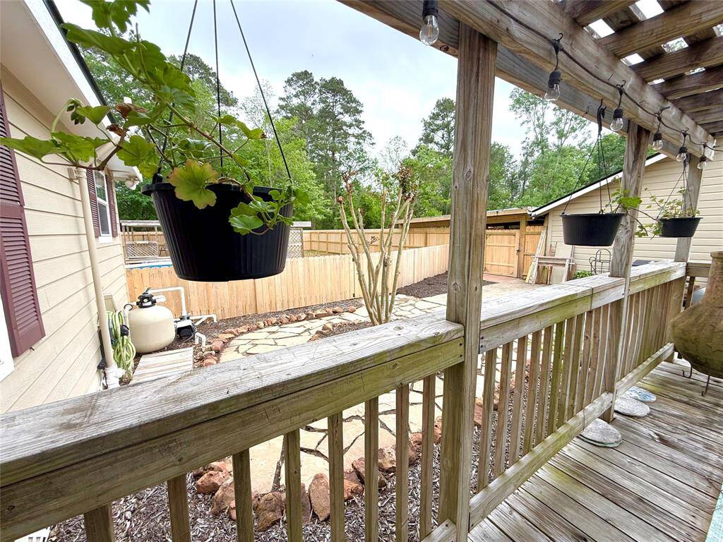Back porch, pool is beyond the fence