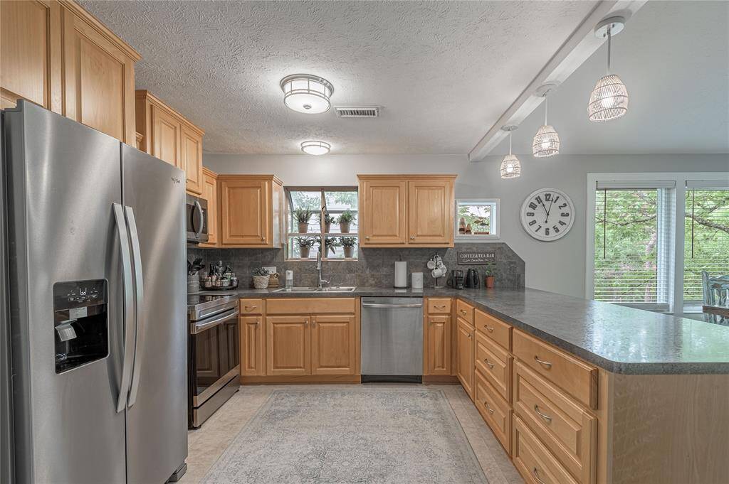 Kitchen has plenty of counter top space along with cabinets.