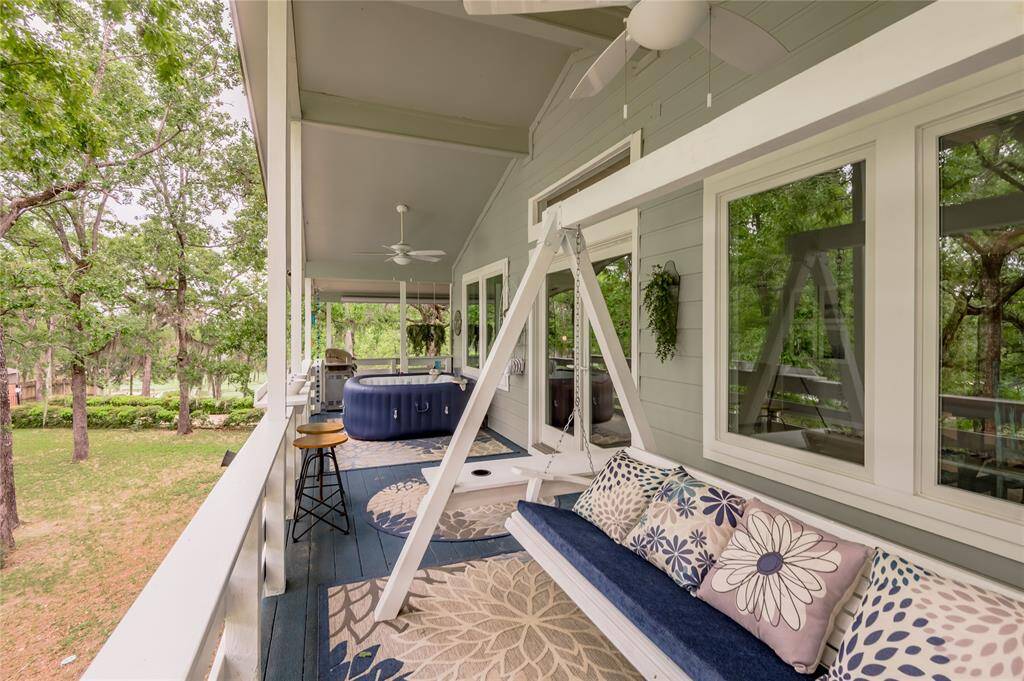 Wrap around porch has tree top views.  You will be able to sit in the hot tub or swing enjoying your favorite beverage while gazing at the breath taking views.